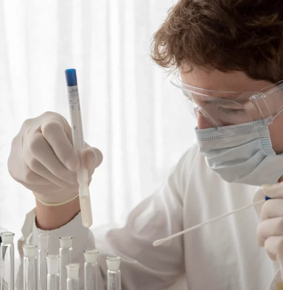 close-up-scientist-looking-flask
